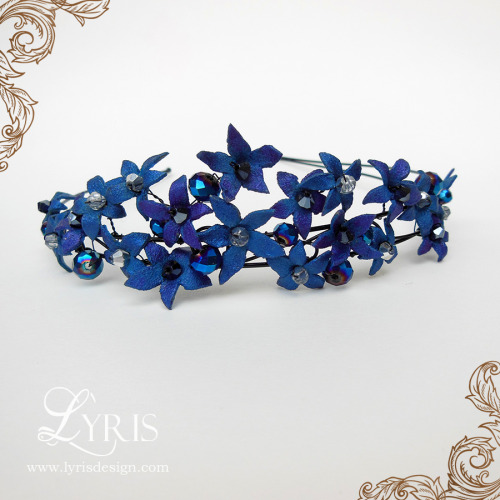 Each flower on this beautiful headband was hand sculpted and painted, and adorned with sparkling Swa