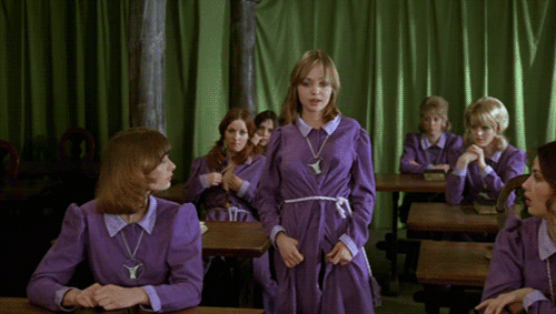 Minet naughtily lifts up the hem of her school uniform during her speech about the zodiac signs.   - From the 1973 Danish movie I Jomfruens tegn (In The Sign of the Virgin, also known as Danish Pastries),                   an adult comedy film more or