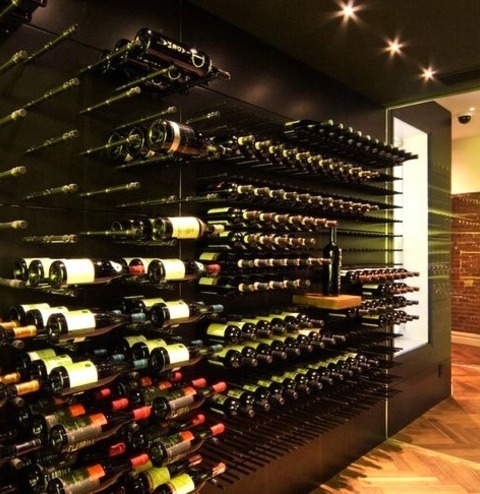 Wine Cellar - Medium Mid-sized Minimalist Medium Tone Wood Floor Wine Cellar Photo With Storage Racks