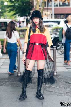 tokyo-fashion:  Japanese high school student SaraH on the street in Harajuku wearing a belted DHL shirt with a handmade sheer skirt, Demonia lace-up boots, a fuzzy Kangol bucket hat, and floral Eastpak crossbody bag. Full Look