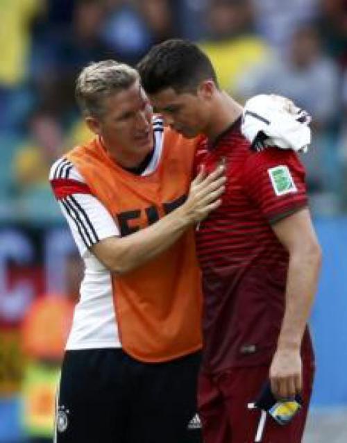 Bastian Schweinsteiger and Cristiano Ronaldo after the German team trashed Portugal 4-0, in group G 