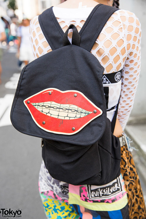 Pierced and tattooed Momoko on the street in Harajuku wearing a DVMVGE top, Nanananoka shorts, YRU p