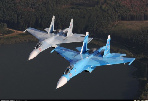 planesawesome:   The Su-27SM in dark blue livery and Su-27SM3 in light blue livery flying in formation  