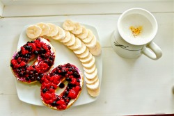 let-you-define-you:  12 grain bagel with cream cheese and warm raspberries and blueberries, a sliced banana, and a chai tea latte! 
