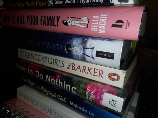 a stack of books with spines facing out that includes 'How To Kill Your Family', 'How To Do Nothing' and 'The Silence Of The Girls'. 