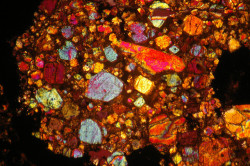jtotheizzoe:  via odditiesoflife:  A Look Inside a Meteorite Ever wonder what a meteorite looks like inside? These image were made in cross-polarized light, where a polarizer between the light source and the microscope slide is rotated. The beautiful