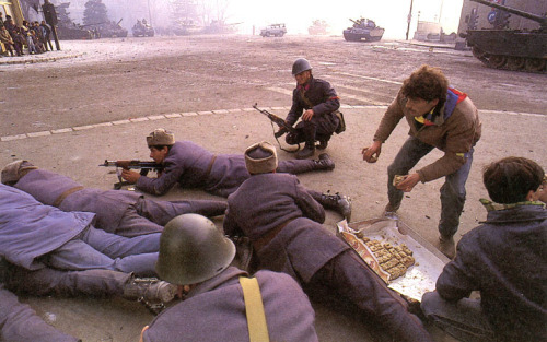 historylover1230:Romanian troops fighting against unidentified attackers while being served cake by 