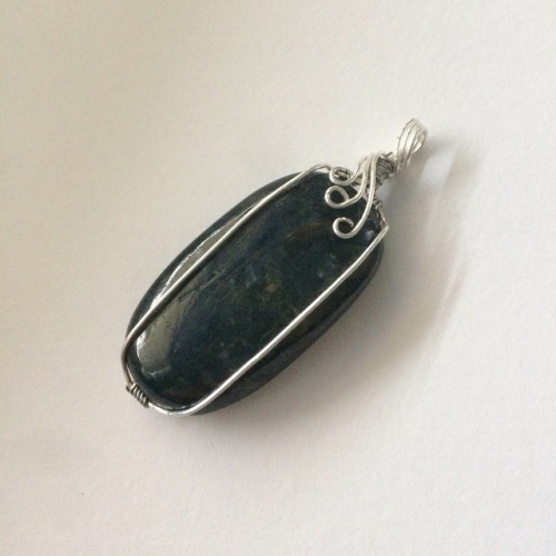 Midnight blue kyanite in a silver wire frame.