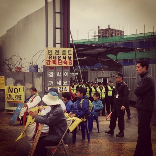 The 2,723rd day of protesting the construction of a U.S. Naval base on the shore of Gangjeong. Each day protestors congregate to block traffic in and out of the base. Every twenty minutes or so police come, pick up the protestors in their chairs and...