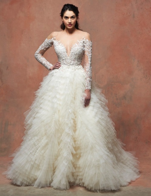 This romantic Enaura princess wedding dress features an illusion neckline and long sleeves adorned w