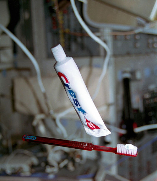 Toothbrush and toothpaste floating in microgravity during STS-70