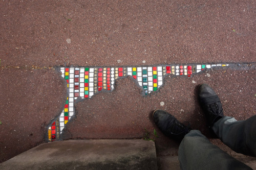 EmEmEmLyon-based artist EmEmEm repairs holes in sidewalks and walls with colorful mosaics. EmEmEm’s 