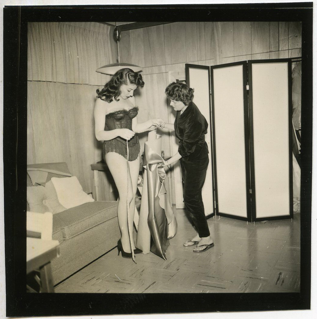 Rusty Lane (”The Duchess of Dis-Robe”) gets fitted for a new dance costume created