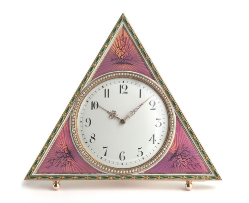 The Tsarina's Fabergé Clock, triangular, gold centred by a white enamel dial, with Arabic chapters a