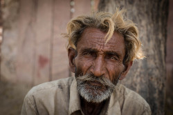 jacksgap:  I met this man during my travels in India. I passed him as he was trying to tie a bit of string around one arm to make a bracelet. He was using his teeth but was struggling and so I offered my assistance. He seemed pleased by this and once