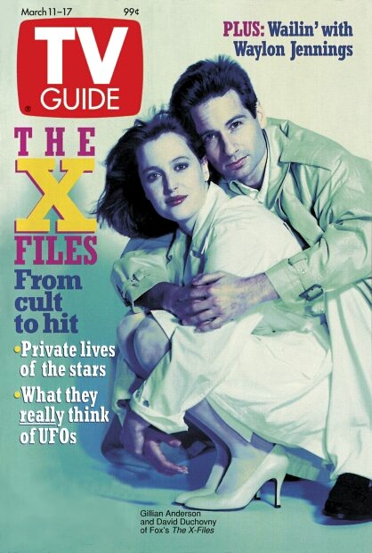 xfilesbaby:  youokay-mulder:  TV Guide March 11, 1995 by Deborah Starr Seibel  David Duchovny is not happy. He stands behind Gillian Anderson in a barebones photo studio, resigned to having roll after roll of pictures taken on what promises to be another