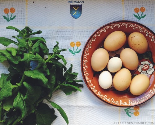 Breakfast from our yard: spinach &amp; homegrown eggs. To be served on top of this cross-stitched ta