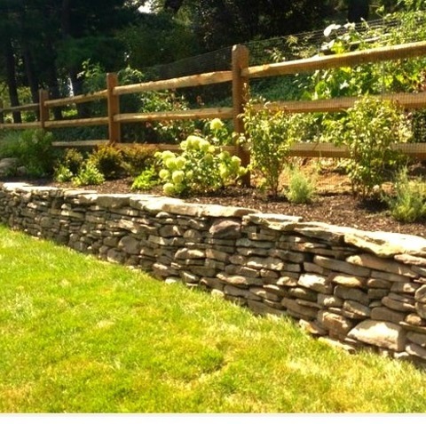 Philadelphia Retaining Walls LandscapeAn Example Of A Mid-sized Traditional Partial Sun Backyard Stone