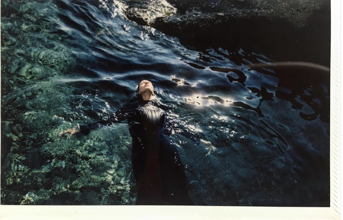 Floating in a rocky pool