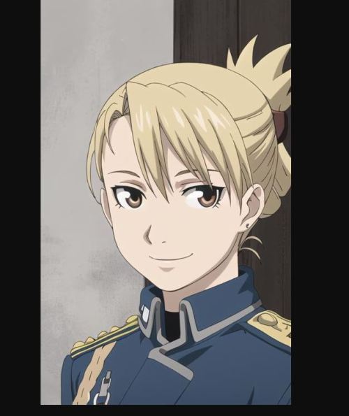 An adult woman with blonde hair and brown eyes standing in front of what looks like a wooden door. Her hair is pulled back in a loose bun and she is smiling gently at someone out of frame. She is wearing a blue military uniform with a gold trim.