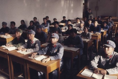 Students, dressed up in military uniforms, attend classes at Beijing University during the Cultural 