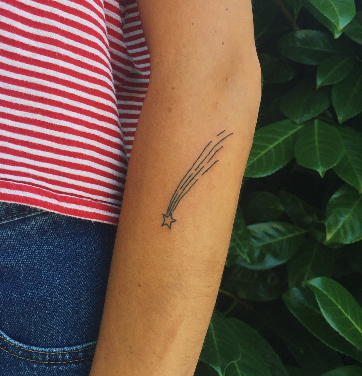 Watercolor pisces constellation tattoo on the bicep.