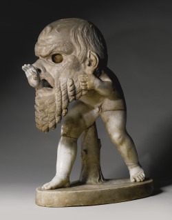 workman:   archaicwonder: Marble Figure of a Young Satyr wearing a Theater Mask of Silenus, Roman Imperial, circa 1st Century ADThe satyr stepping forward menacingly, wearing over his head and shoulders an oversized comedy mask of an old satyr (Silenus),