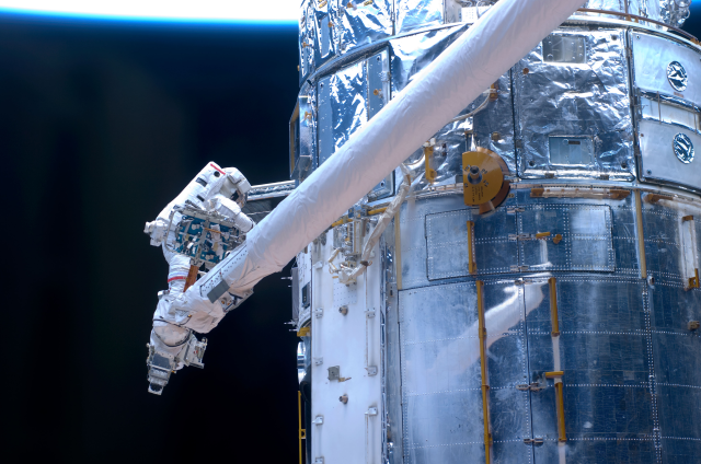 Astronaut John Grunsfeld works on repairs to the Hubble Space Telescope. 