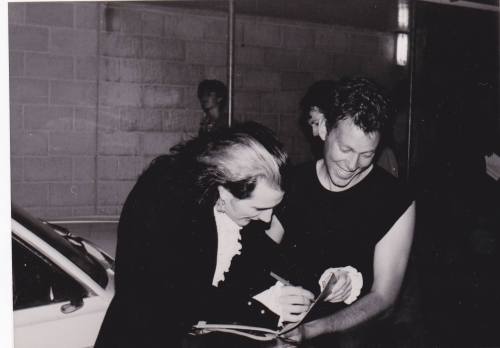 Dave Vanian happily signing an autograph for a fan.