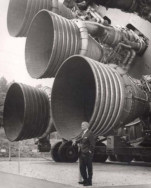 Wernher von Braun standing next to the F-1 engines on the Apollo Saturn V rocket 