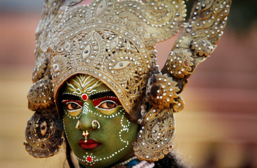 artofprayer: A woman dressed as Kali, a Hindu goddess, in a procession before the Shivratri Festival