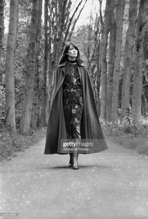 Françoise Hardy wearing a Liberty wool challis print floral dress and a long cape, red boots, all by