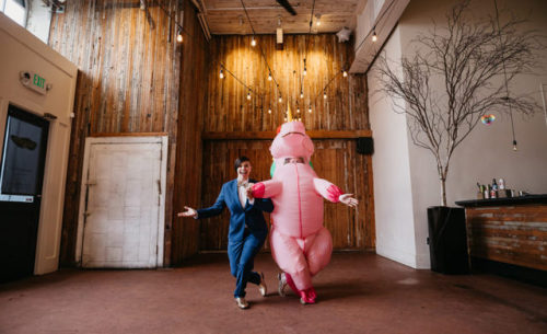  Michelle surprised Amie in a blow up unicorn suit for their first look. Then Amie “unwrapped&