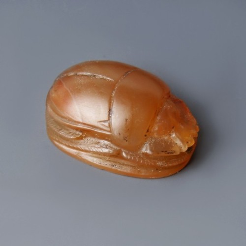 Carnelian Scarab AmuletA beautiful Egyptian scarab amulet made in bright carnelian. The front depict