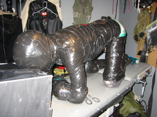 ropenbag:  Transformation Through Mummification: Start with a willing or semi willing victim. Add a gag, then head gear, pads as needed and just keep going.  He can no longer complain or resist.  once semi secured, add milker, electric plug, then excess