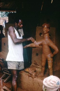 ukpuru:  Godwin, the apprentice of the architect Akakporo of the Mbari [votive earth shrine] models a figure in an Mbari in Nnorie near Owere, Igbo peoples, Nigeria. Photo by Herbert M. Cole.