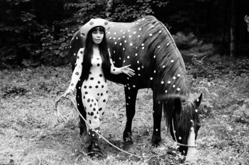 In this 1967 photo released by Yayoi Kusama Studio Inc., Japanese artist Yayoi Kusama poses with a h