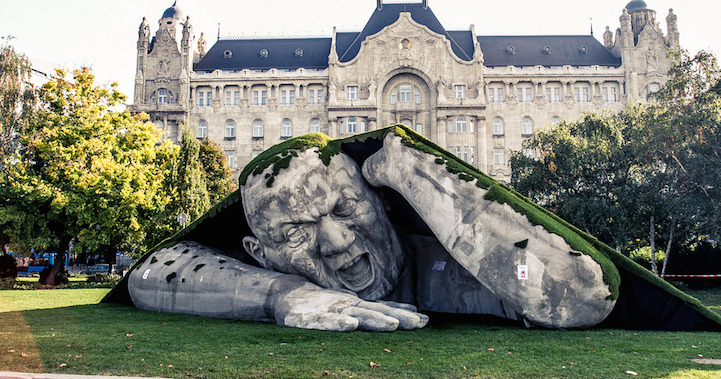 mymodernmet:  A gigantic man crawls out from the earth in this spectacular outdoor