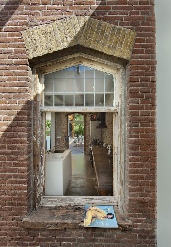 Rustic exposed brick walls outside and inside kitchen.