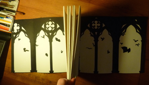 lorenzocheney:Here’s what I made for week 2 of bookbinding! It’s got cutouts of cathedrals and bats 