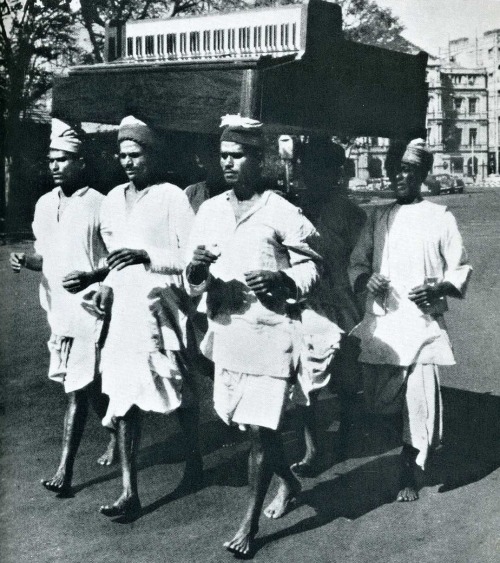 In Bombay, delivery men demonstrate an easy way to carry a tune.