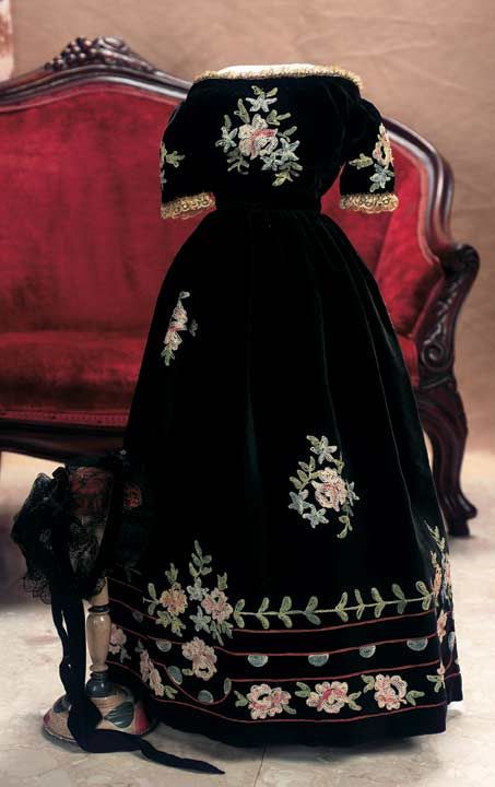 Black Velvet Gown with Embroidered Flowers with Black Velvet and Lace Coiffe  Circa 1870.