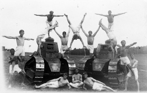 Polish Army gymnastics team posing with a pair of Renault light tanks, 1931.