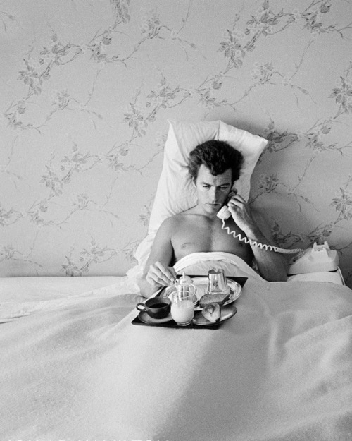 Clint Eastwood having breakfast in bed, at home in North Hollywood, California (1958)