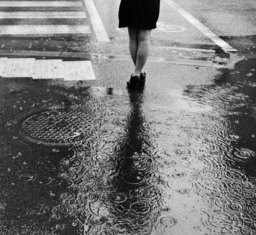 The circles of the manhole in the circles of rain drops. Japan 2010 Leica film scan, cropped