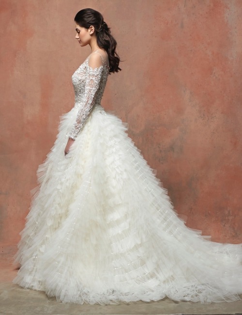 This romantic Enaura princess wedding dress features an illusion neckline and long sleeves adorned w