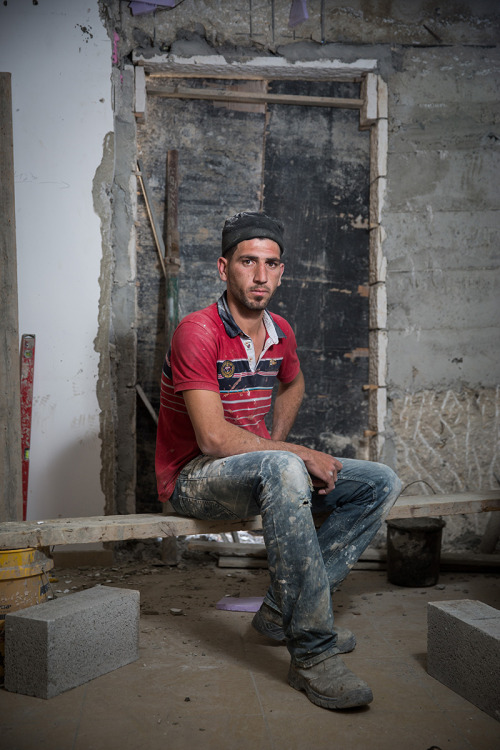 Portrait of a Palestinian construction worker, Muhammed Abu Khabir, in a house being renovated, at t