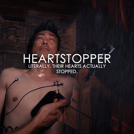 Gif 7: A blended gif of Buck and Chimney. The left shows Chimney from 5x17. He is shirtless and unconscious, and Jonah (offscreen) places paddles on Chimney's chest. The right shows Buck in 6x10. He is in his firefighter gear and dangling from the ladder, unconscious. It is raining. The overlayed large white font is: "HEARTSTOPPER". Underneath it in smaller font is: "LITERALLY. THEIR HEARTS ACTUALLY STOPPED."