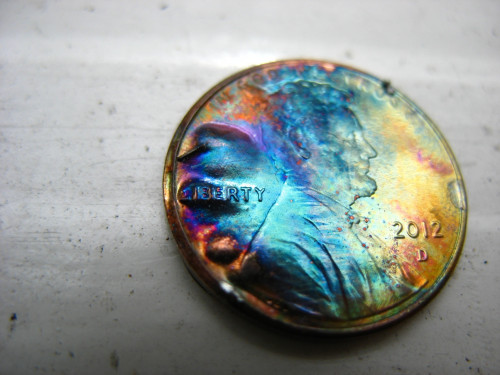 stunningpicture:A firework fell over on the ground and did this to a penny.