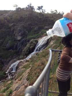 gossipinq:  i tried to take this water spilling out of the water bottle pic at this waterfall and my mum happened to be in the picture and she looks like she is getting crushed by the bottle 